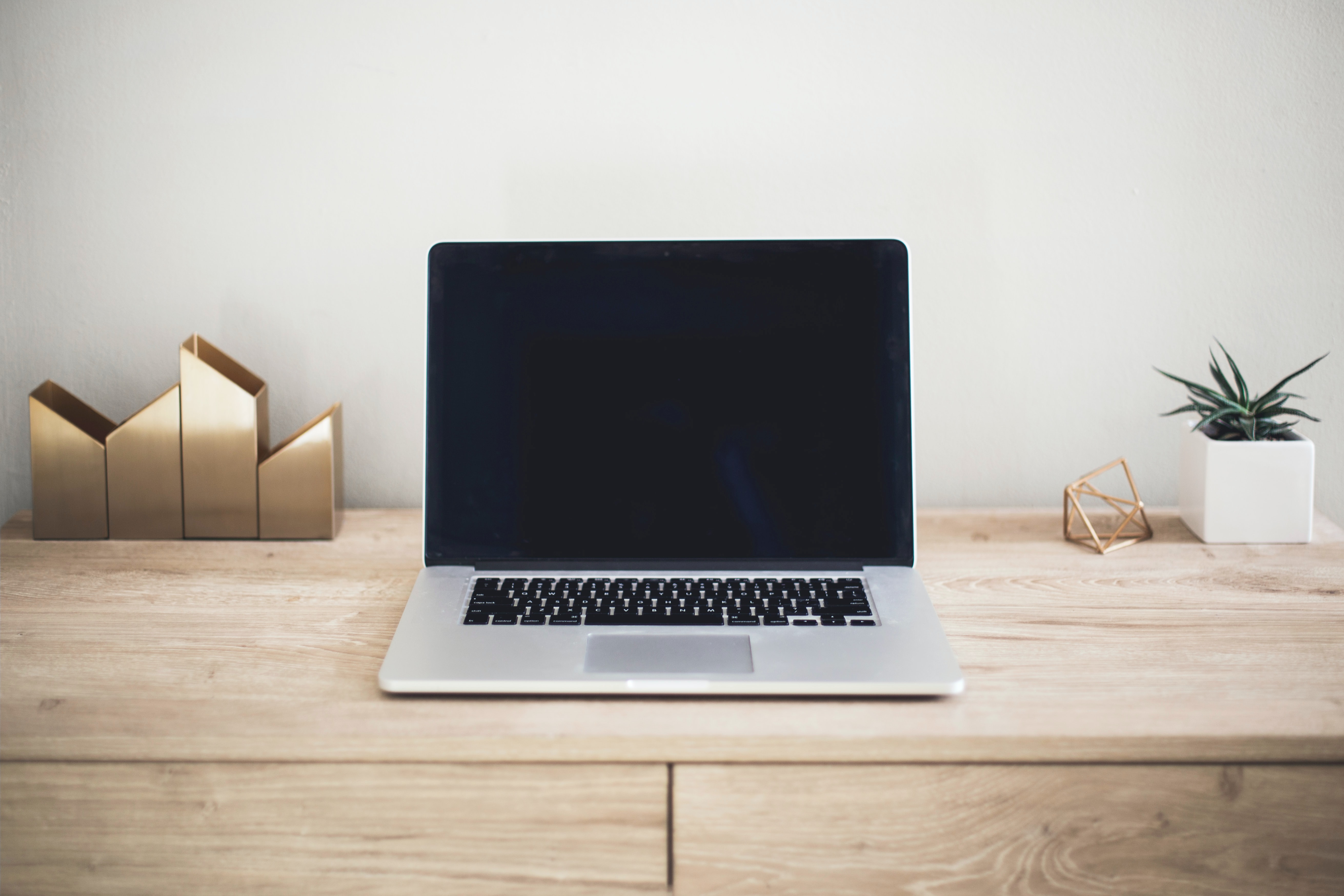 laptop on a desk with a blank screen