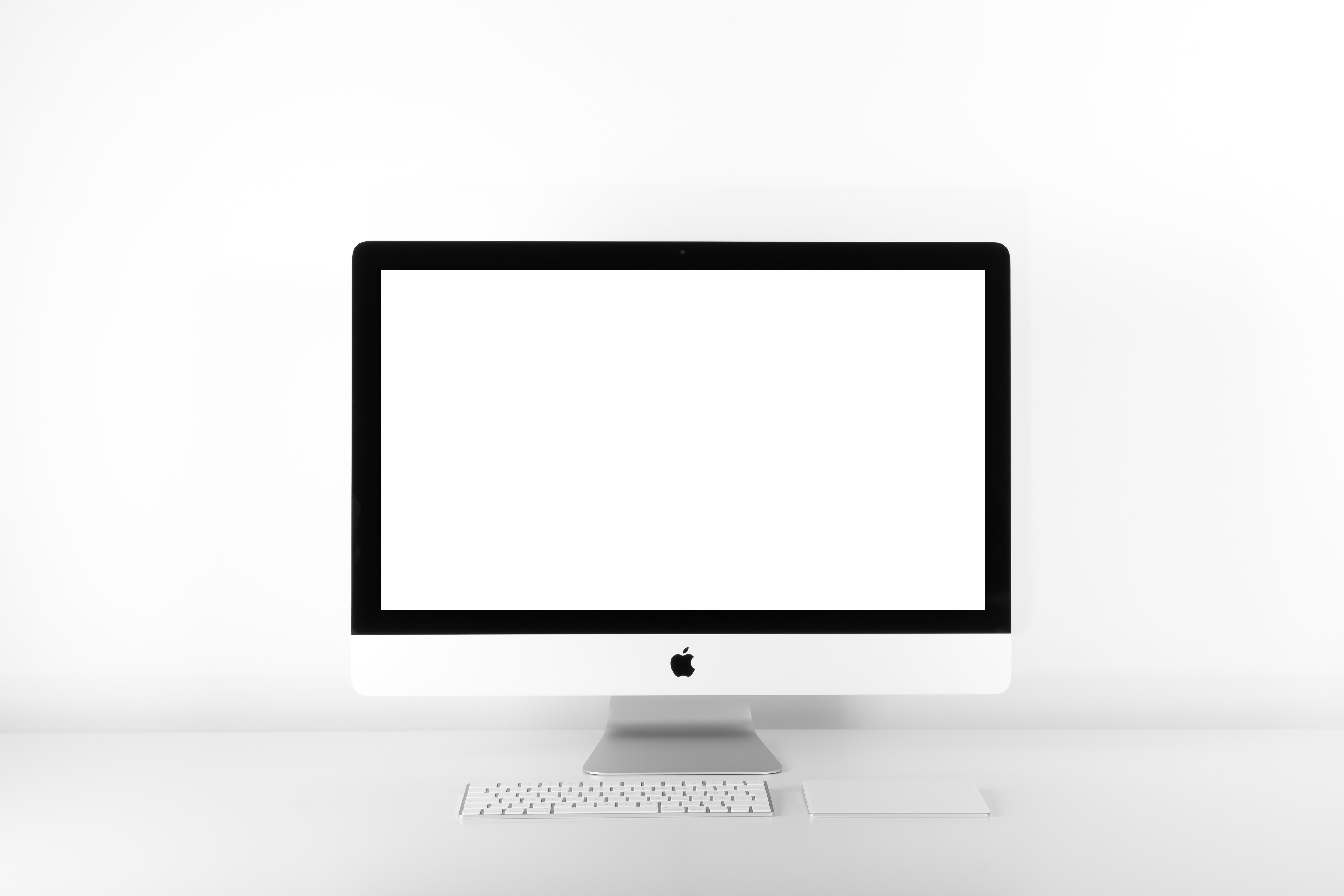 Mac desktop on a white desk